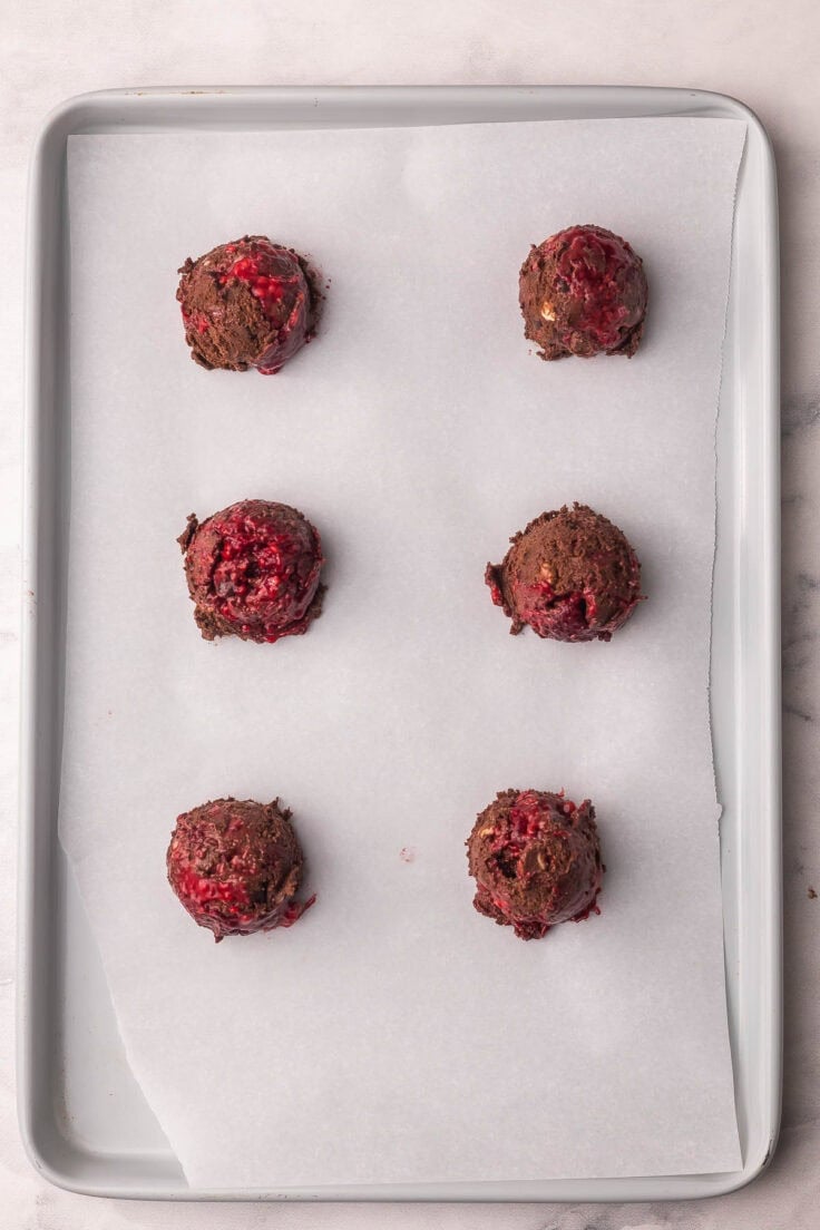 scooped cookie dough on parchment lined pan.