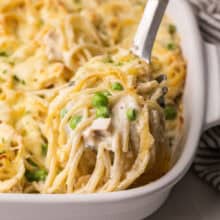 a scoop of turkey tetrazzini coming out of pan.