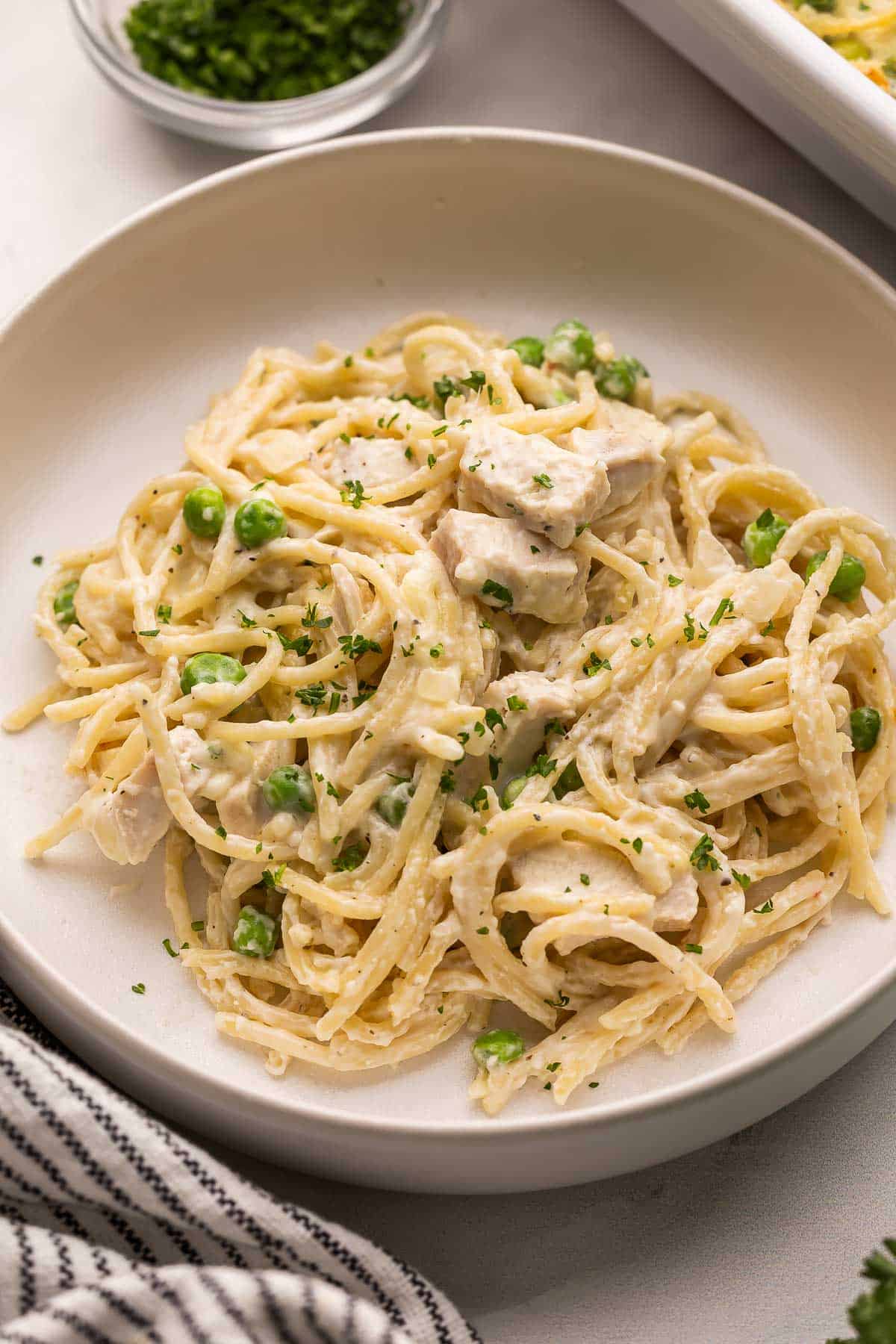 large bowl of turkey tetrazzini topped with chopped parsley.