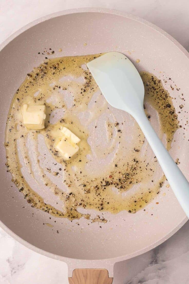 butter added to other ingredients in frying pan.