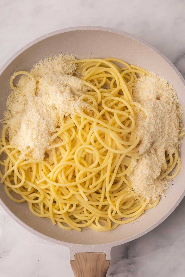 shredded cheese added to cooked pasta.