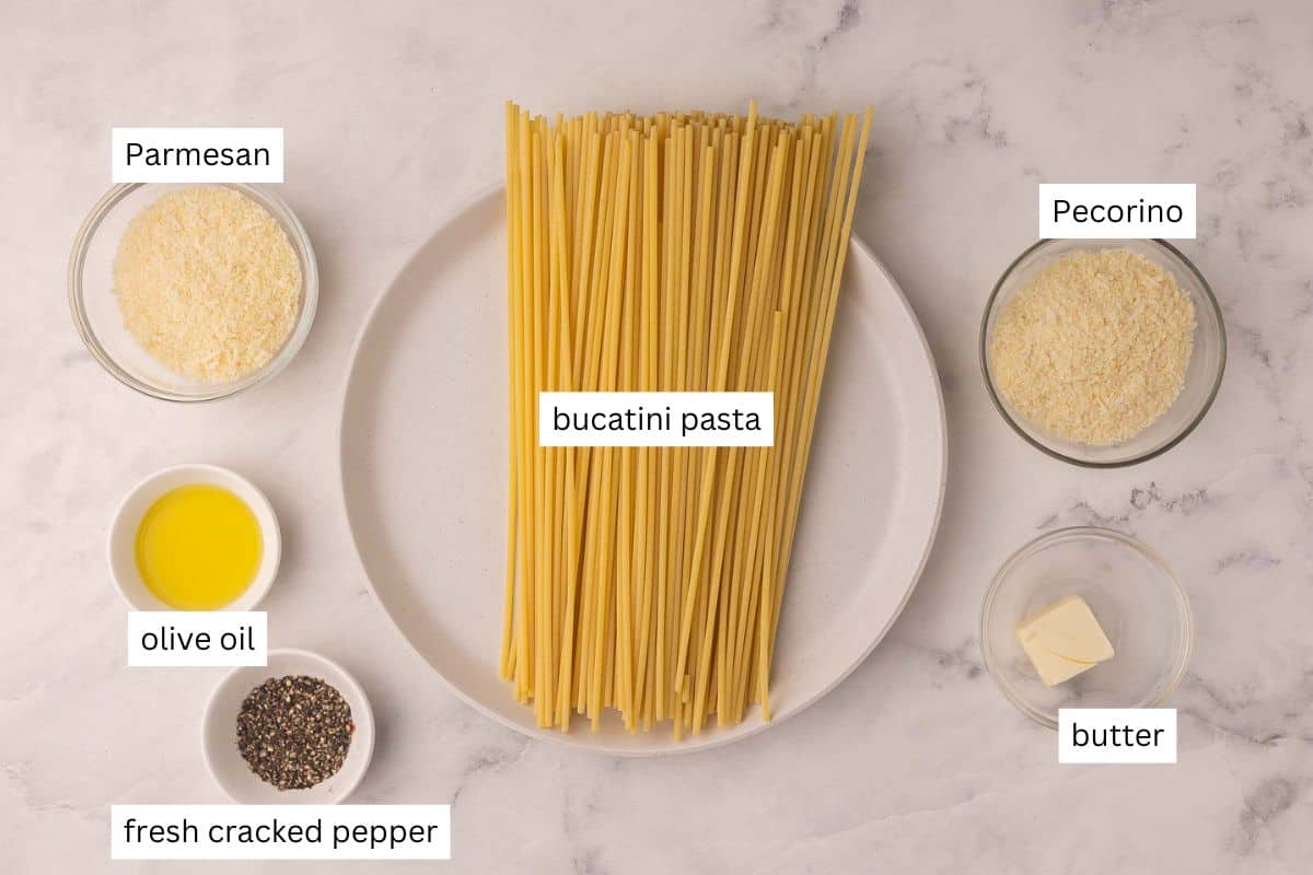 This 20-minute Cacio e Pepe recipe is creamy, peppery, and made with just 6 ingredients. Featuring al dente pasta, freshly grated Parmesan, and cracked black pepper, it's simple Italian comfort food at its best! #pasta #dinner | easy recipes | easy dinner recipes | pasta recipes | 20 minute meals | 30 minute meals | italian food | parmesan | cracked black pepper ingredients needed for cacio-e-pepe in bowls and plate.