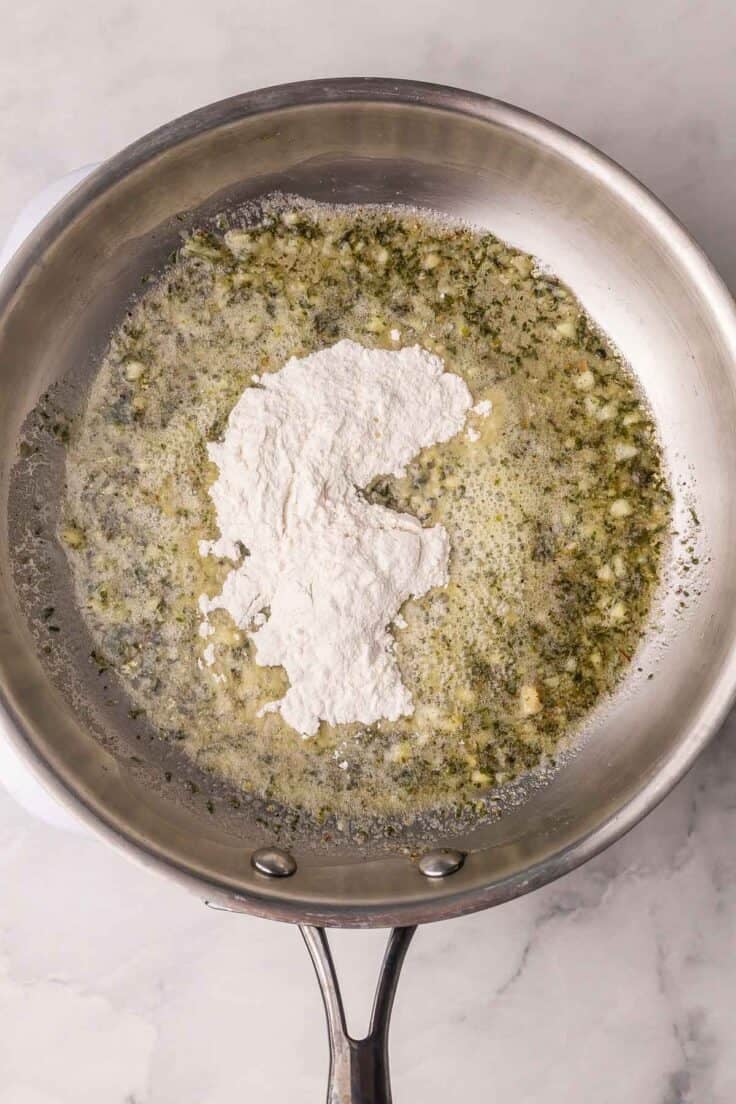 flour added to other ingredients in steel pan.