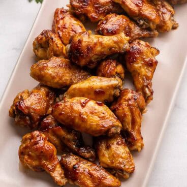 pink tray full of chicken wings.