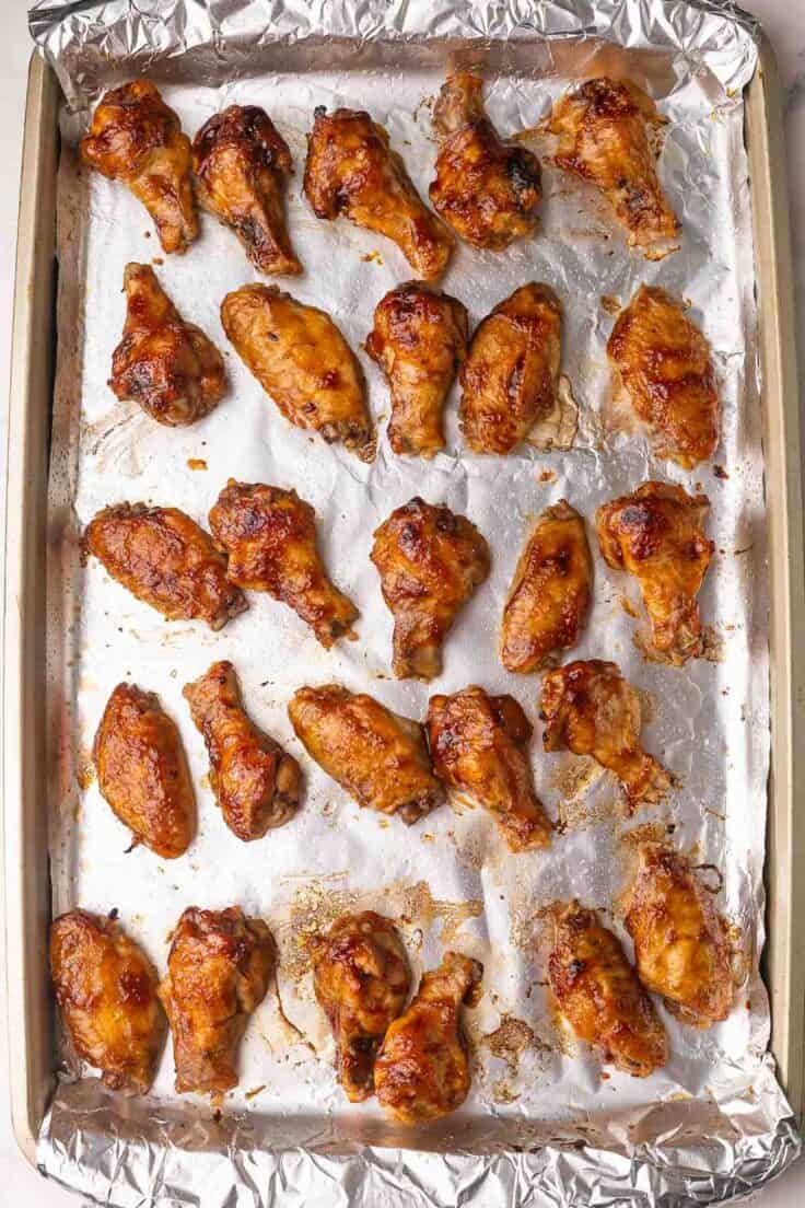 tinfoil lined pan full of chicken wings.