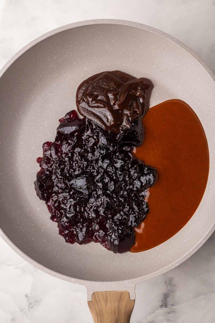 frying pan with unmixed sauces and grape jelly.
