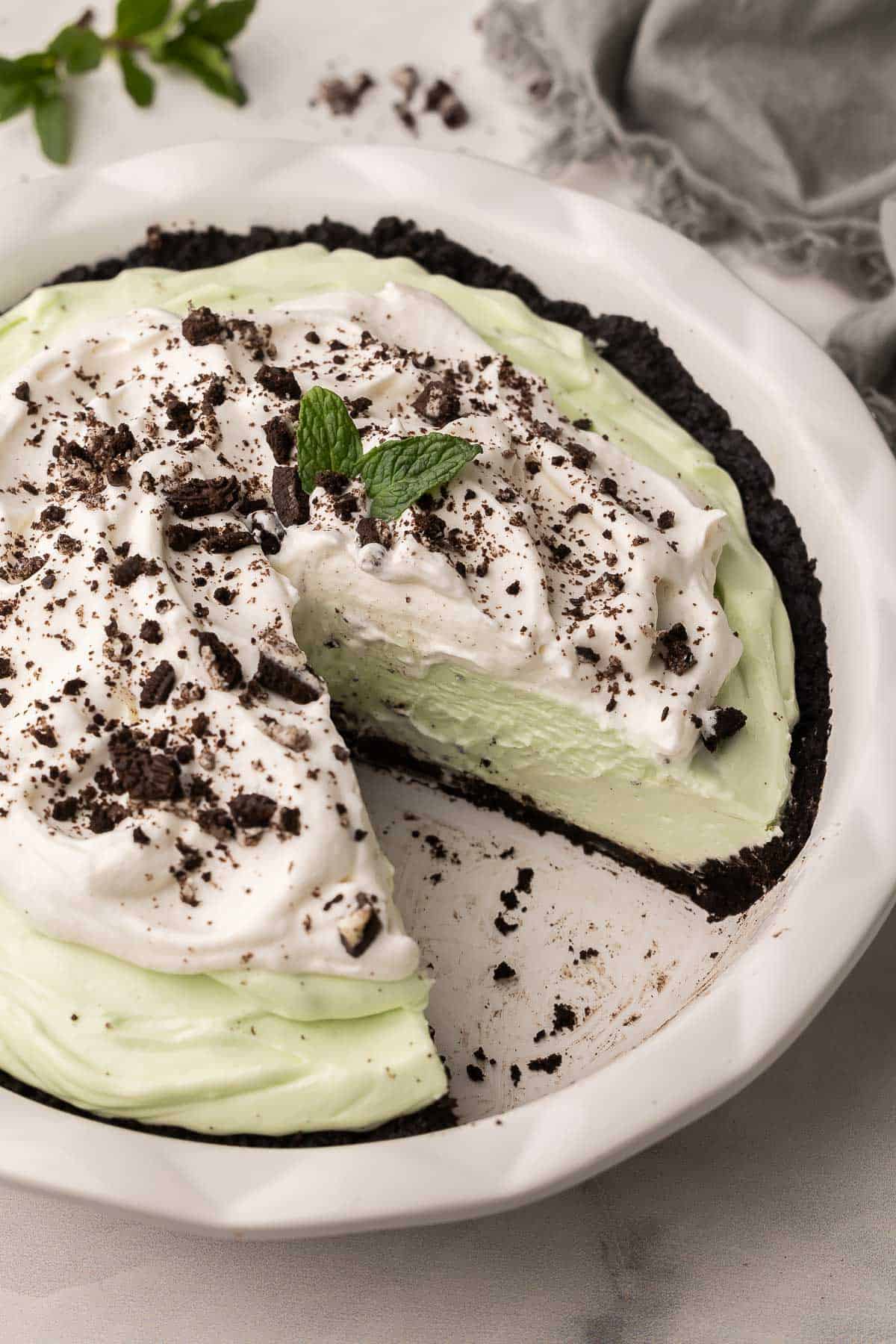 grasshopper pie in a white pan with a piece missing.