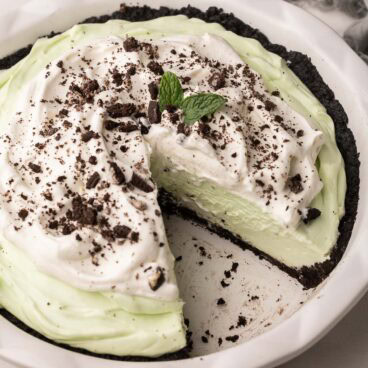 a piece missing out of a pan of grasshopper pie.