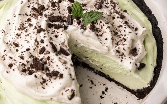 a piece missing out of a pan of grasshopper pie.