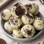 oreo balls in a blue bowl with a bite taken out of one.