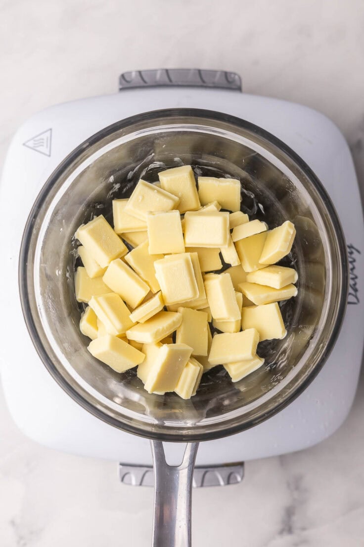 white chocolate in a glass bowl over a boiling pot of water.