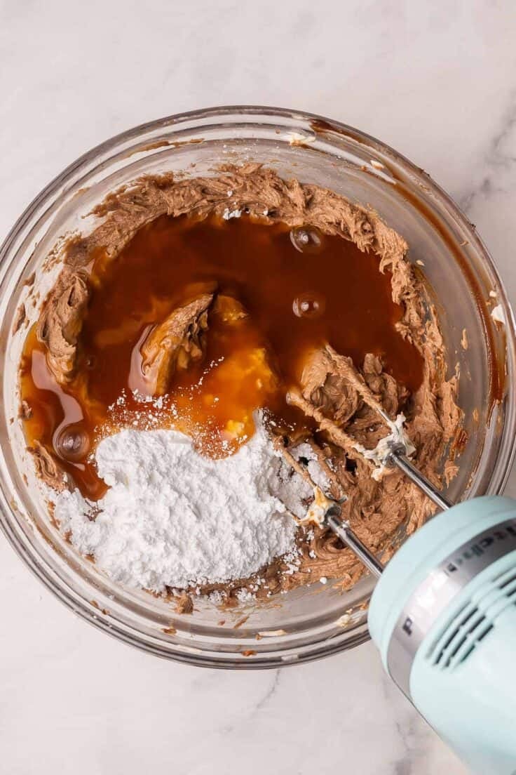 caramel sauce added to other ingredients in glass bowl.