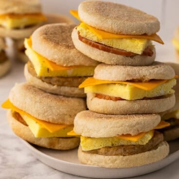 a stack of breakfast sandwiches on a plate.