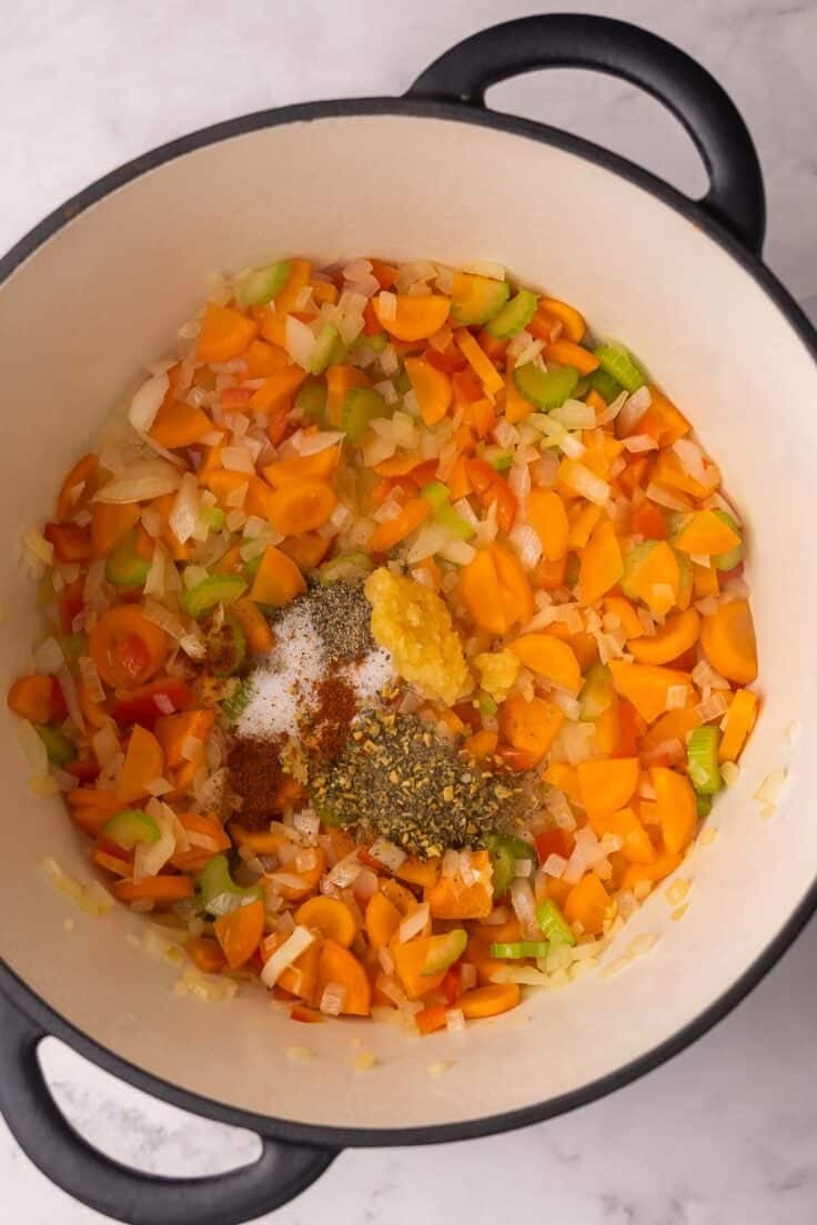 sauteed vegetables in pot with spices added.