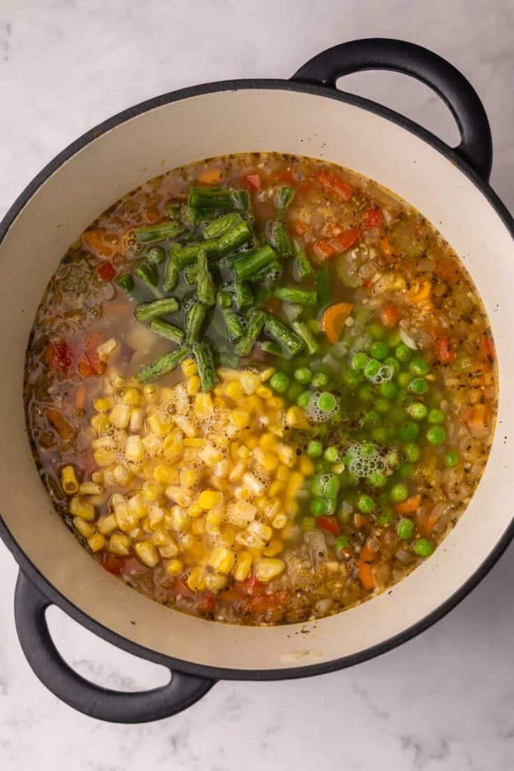 frozen vegetables added to large pot of soup.