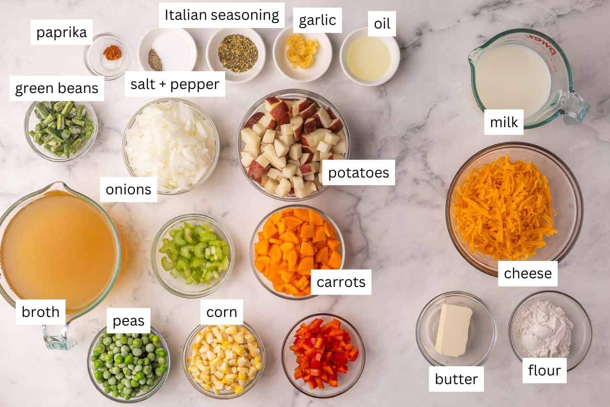 Cozy up with this thick and Creamy Vegetable Soup! Packed with potatoes, carrots, corn, peas, and melty cheddar, it’s a hearty 30-minute dinner the whole family loves (and our favorite way to eat our vegetables!). #soup #dinner #recipe | easy dinner ideas | easy dinner recipes | soup recipes | healthy soup | comfort food | vegetable soup | vegetable chowder | cheesy soup | creamy soups | healthy recipes ingredients needed for creamy vegetable soup in bowls.