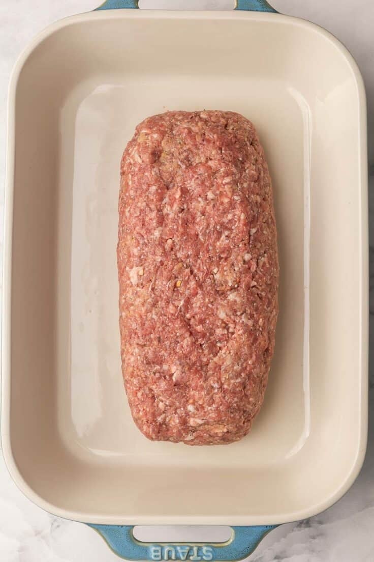 large baking dish with a formed meatloaf.
