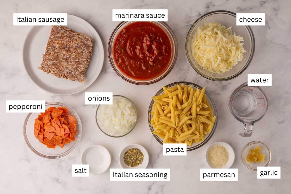 This Pizza Pasta Bake is cheesy, hearty, and loaded with sausage, pepperoni, and marinara. It's like pizza night and pasta night all in one dish! It's make ahead and freezer friendly weeknight meal. #dinner #recipe | make ahead meal | freezer meal | pasta bake | pepperoni pizza | italian sausage | comfort food | easy dinner ideas | dinner recipes ingredients needed for pizza pasta with ingredients in bowls and plate.