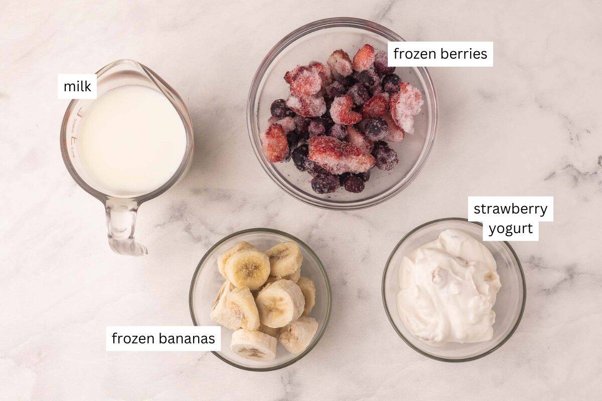This easy Mixed Berry Smoothie is creamy, refreshing, and packed with strawberries, blueberries and raspberries! Ready in 5 minutes and is the perfect healthy breakfast or snack. #breakfast #smoothie #drink | summer drinks | healthy snack | healthy breakfast | blueberry | strawberry | raspberry ingredients for berry smoothie recipe on marble background.