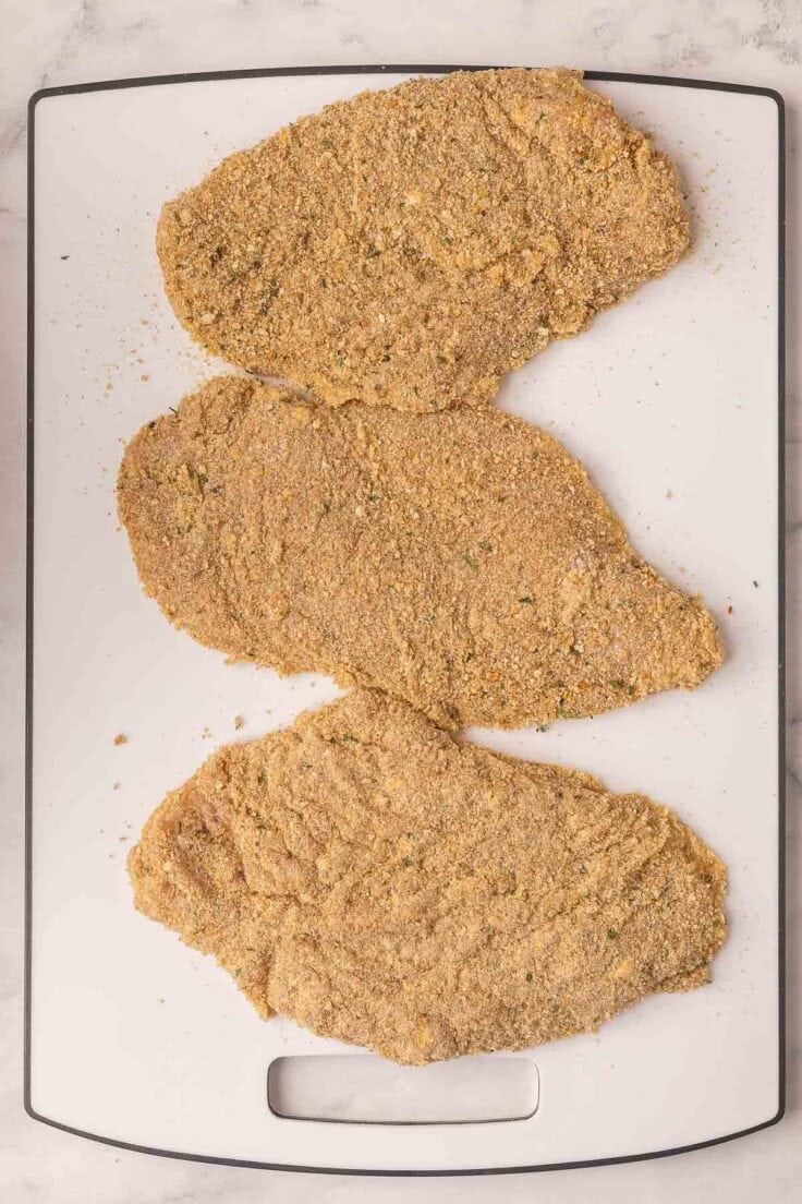 chicken breasts breaded and ready to cook.