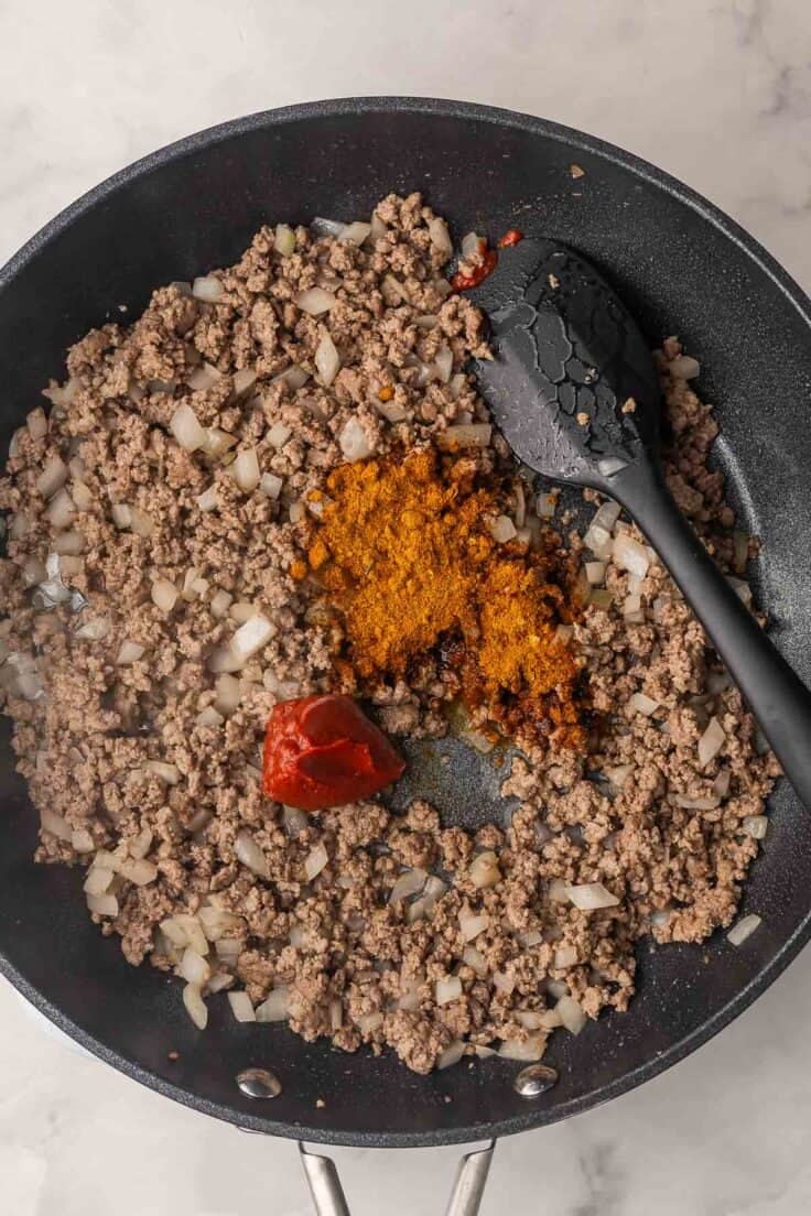 cooked ground beef with spices for taco meat added.