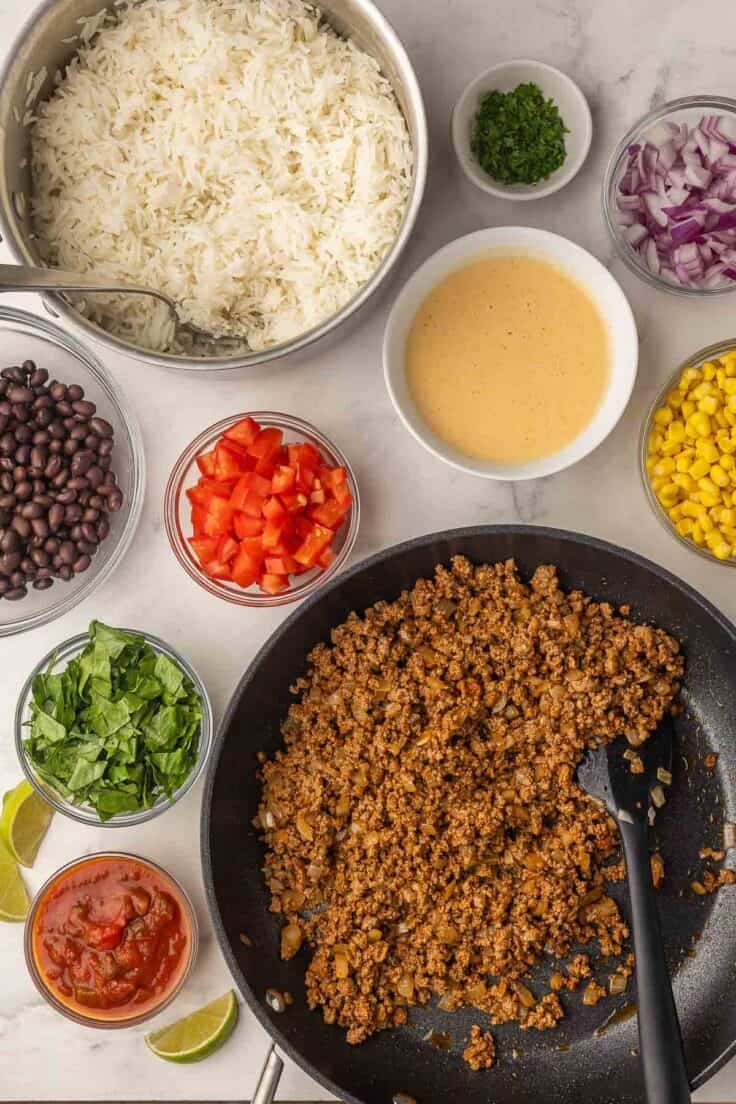ingredients needed to build burrito bowls on a white background.