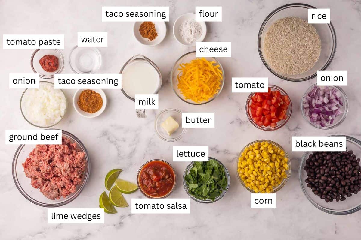 Easy Ground Beef Burrito Bowls with rice, veggies, taco ground beef and creamy nacho cheese sauce! Ready in 35 minutes, totally customizable, and family-approved. #recipe #dinner | easy dinner ideas | ground beef recipes | freezer meals | comfort food | taco night | easy meals | make ahead meals ingredients needed for ground beef burrito bowls on a marble background.