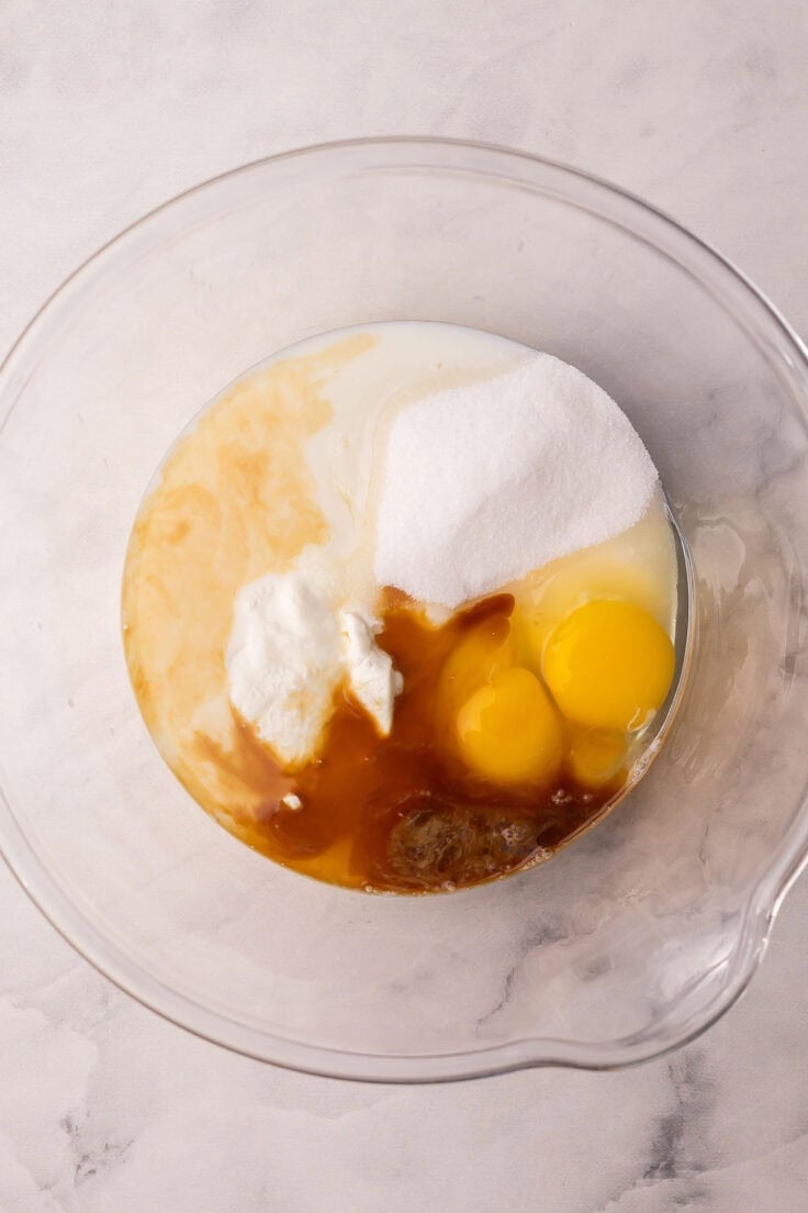 eggs and sugar in a glass mixing bowl.