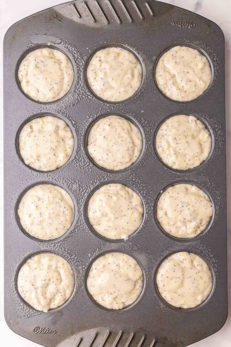 lemon poppy seed muffin batter in muffin pan ready to bake.
