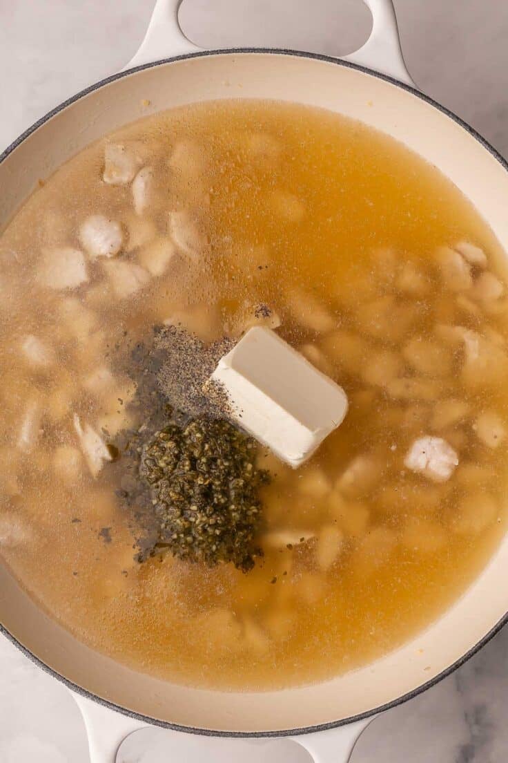 liquid pesto and cream cheese added to the skillet with chicken.