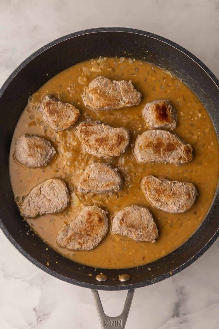 pork medallions added back to skillet with gravy to finish cooking.
