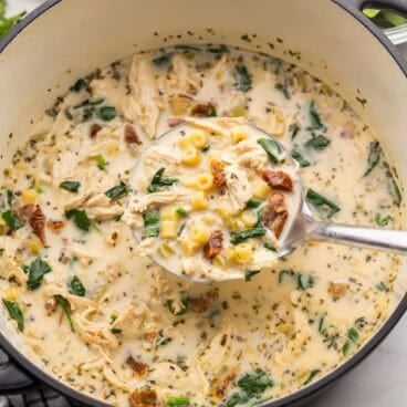 square image of a ladle of tuscan chicken noodle soup coming out of the pot.