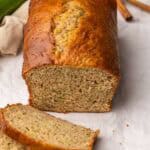 close up of some slices and a loaf of zucchini bread.