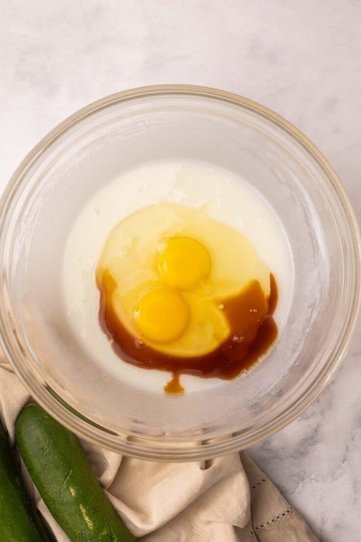 eggs added to glass mixing bowl with other ingredients.