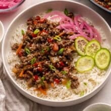 teriyaki beef bowl with red pickled onions beside.