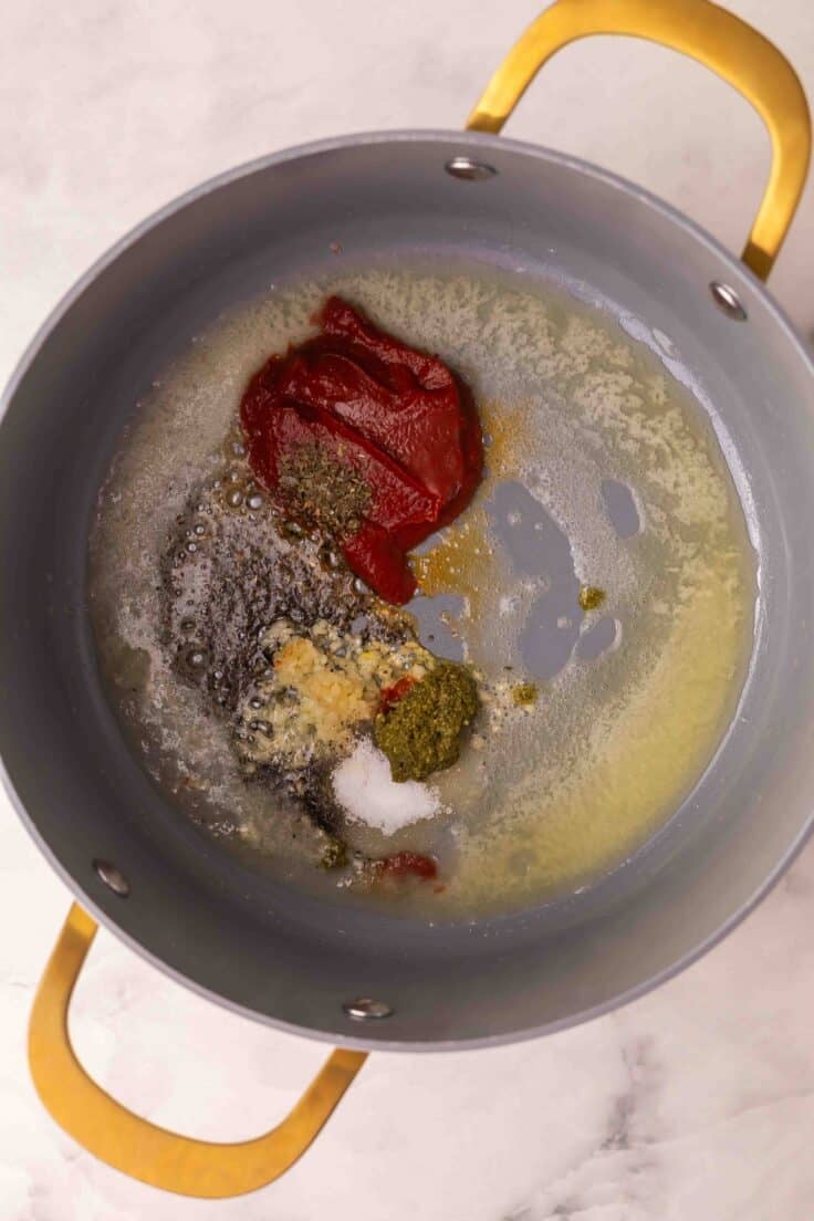 spices added to large pot with melted butter and other ingredients.