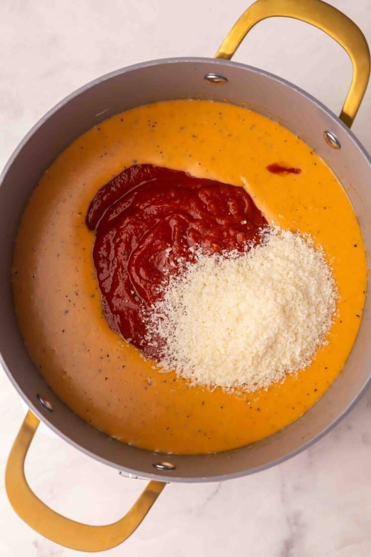 parmesan and crushed tomatoes added to pot with other ingredients.