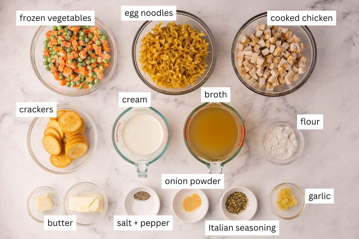 This Chicken Noodle Casserole is classic comfort food ready with just 15 minutes of prep! Tender egg noodles, veggies, and juicy bites of chicken baked in a rich cream sauce. #dinner #recipes | chicken recipes | dinner recipes | easy dinner ideas | casserole | chicken casserole | make ahead | meal prep | chicken breast ingredients needed for chicken noodle casserole in bowls.