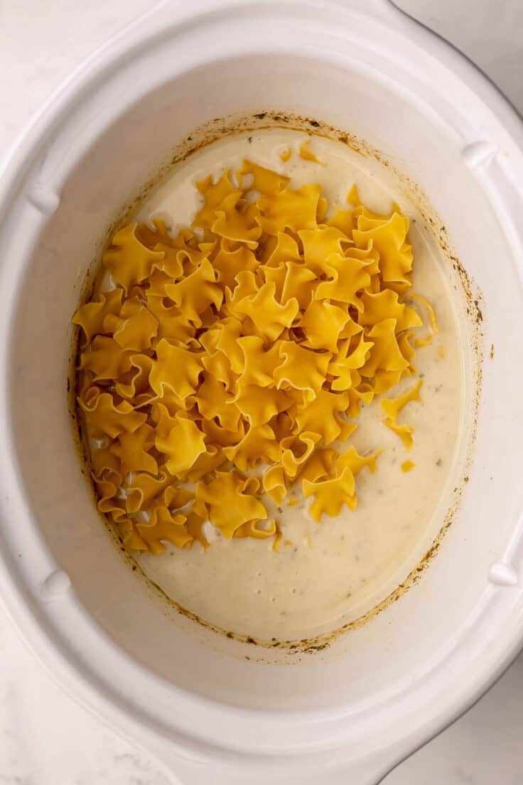 egg noodles added to crockpot with sauce.