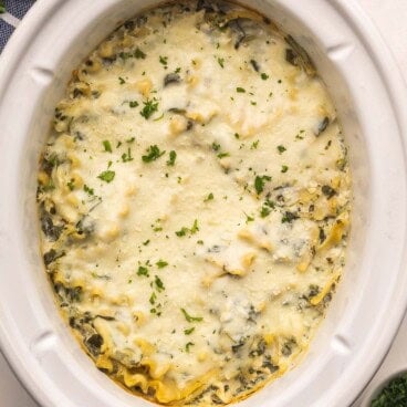close up of white chicken lasagna in crockpot.