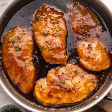 honey garlic chicken in a pan with sauce.