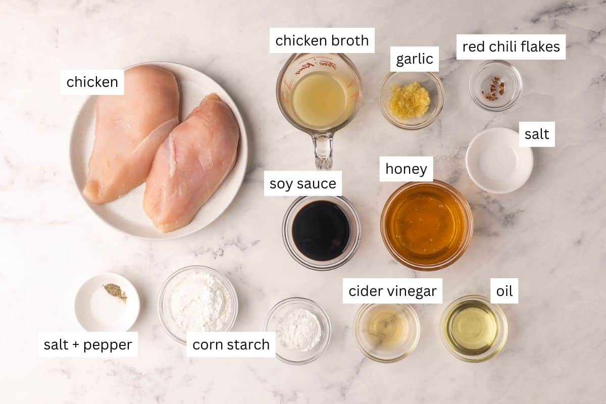 Honey Garlic Chicken is a 25-minute, one-skillet dinner with golden chicken breast in a sweet, sticky honey garlic sauce everyone devours! #chicken #recipe #dinner | dinner ideas | easy recipes | homemade takeout | chicken breast recipes | chicken dinners | meal prep | sauce recipe ingredients needed for honey garlic chicken in bowls and plate.