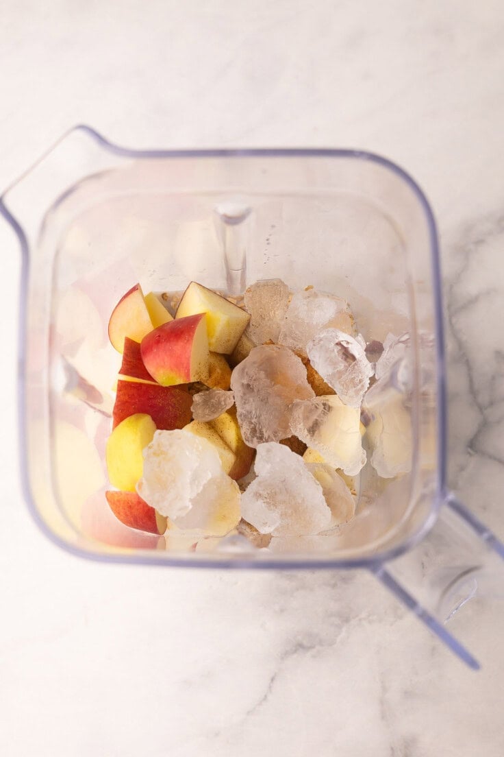 unmixed apple crisp smoothie ingredients in blender.