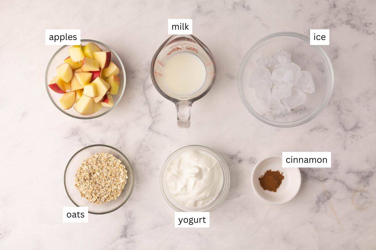 Apple Crisp Smoothie blends apple, oats, vanilla Greek yogurt, and cinnamon into a thick, on-the-go breakfast in 5 minutes, high in protein and fiber with real "apple crisp" flavor! #smoothie #drink #breakfast | smoothie recipe | drink recipes | apple smoothie | healthy smoothie | high fiber breakfast | oats | oatmeal smoothie | apple cinnamon ingredients needed for apple crisp smoothie in bowls.