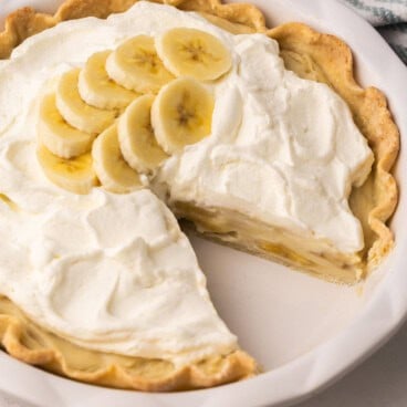 a banana cream pie with a piece missing.