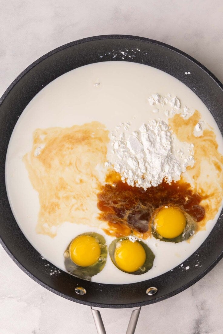 black pan filled with eggs and other ingredients.