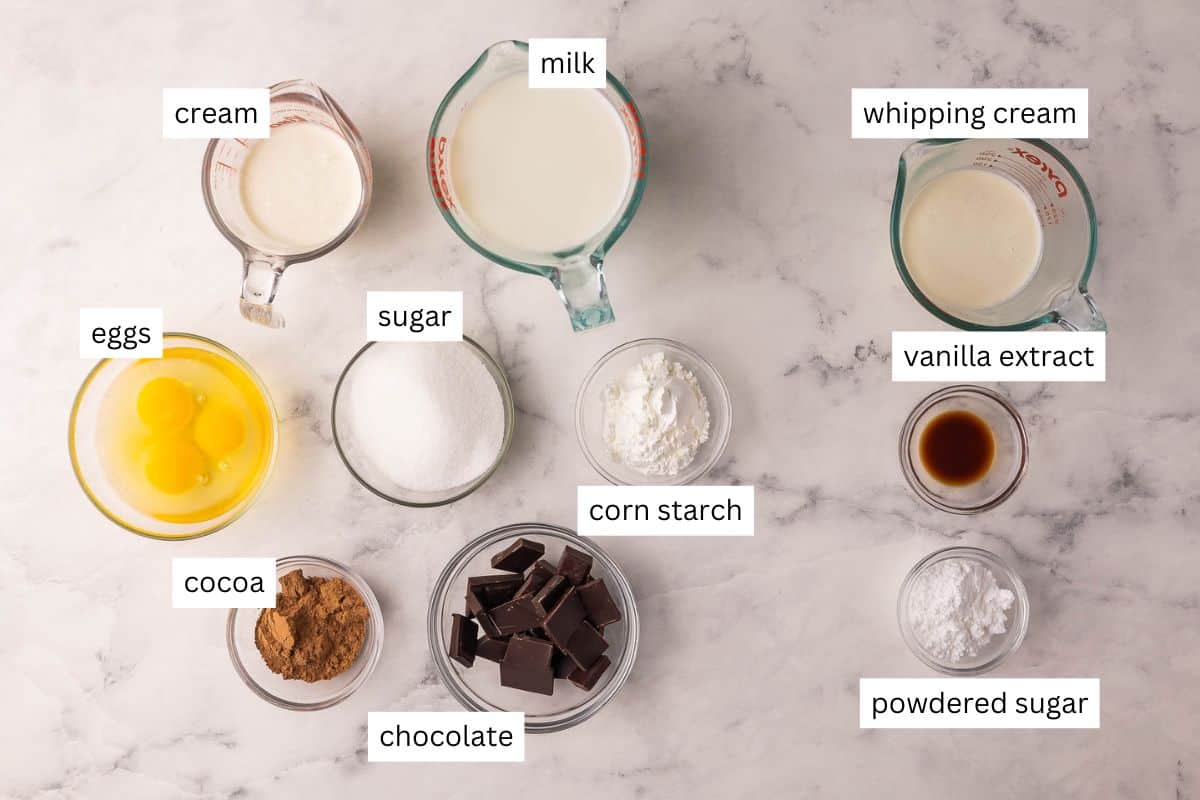 Chocolate Cream Pie is made with a flaky homemade pie crust, thick from-scratch chocolate custard, and a generous layer of homemade whipped cream (chocolate shavings encouraged)! It's the perfect Easter dessert! #chocolate #dessert #recipe | easter dessert recipes | easy desserts | homemade pie | chocolate dessert | homemade pie crust | holiday pies | holiday dessert ingredients needed for chocolate cream pie in bowls.