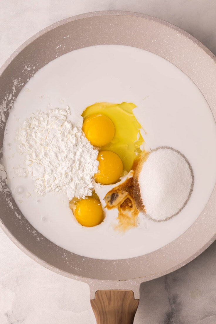 eggs an other unmixed ingredients added to large pan.