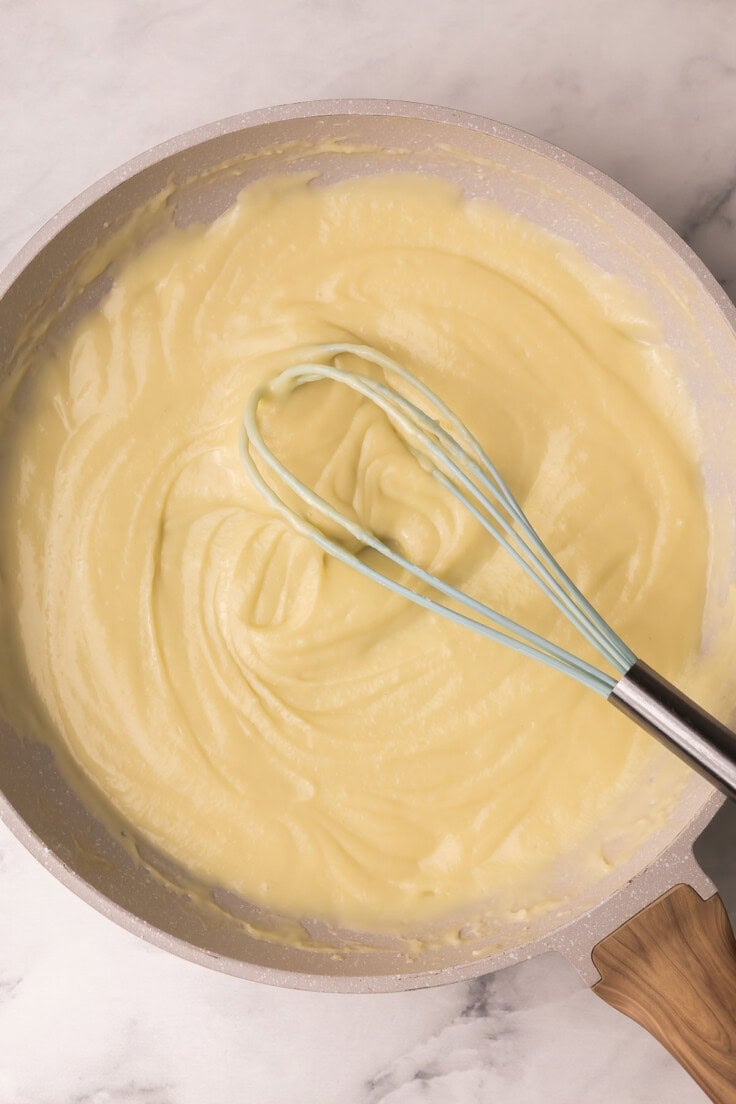 coconut cream filling in pan with whisk.