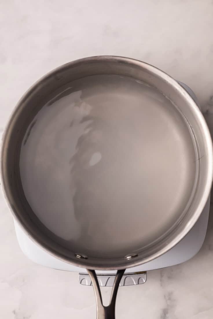 overhead image of water in a steel pot.